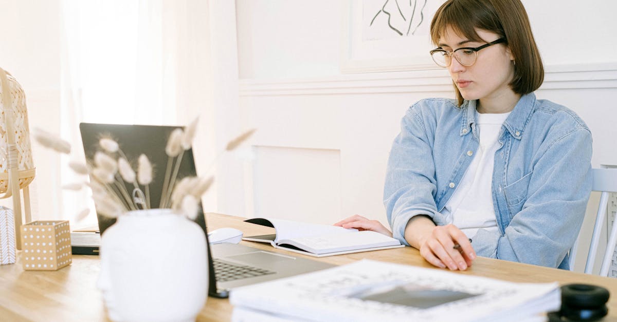 pexels photo 4240507 4240507 Woman working in a stylish home office, taking notes with laptop open on desk.